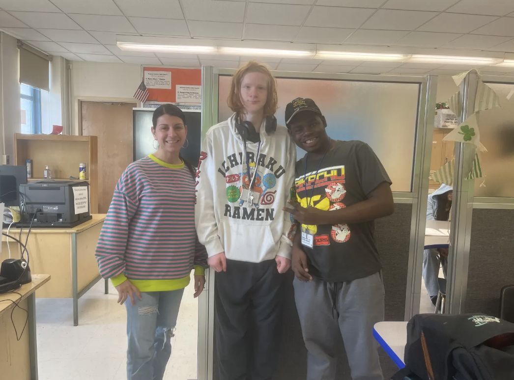 Ms. Franzese poses with two of her students who help her run the snack cart. 